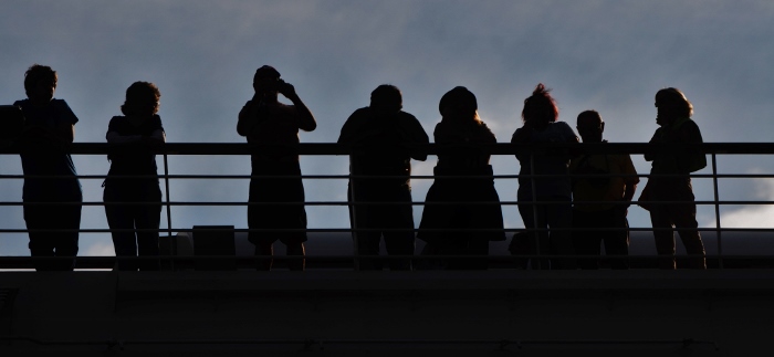 sillhouette of ship passengers on deck